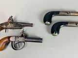 three old revolvers are sitting next to each other on a table