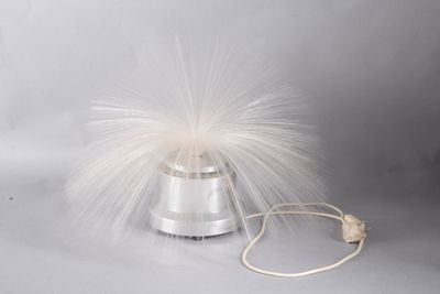 a white feather on top of a silver object