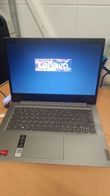 a laptop that is sitting on a desk with a keyboard
