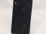 a close up of the back of a black iphone xr on a white surface