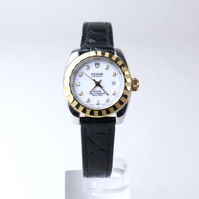 a close up of a wrist watch on a stand