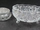 a glass bowl and a glass salt shaker on a table