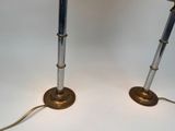pair of brass and glass table lamps on a white surface