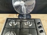 a fan that is sitting on top of a stove