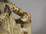 a figurine of a woman holding a child