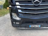a black mercedes truck parked on the side of the road