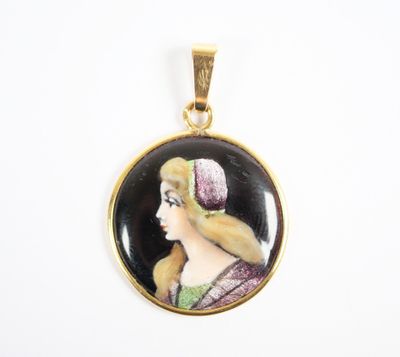 a close up of a pendant with a woman ' s face on it