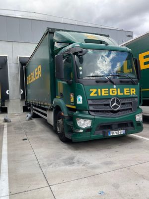 a green truck that is parked in a lot