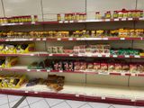 many shelves of food on the shelves in the store