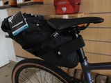 a bike with a bag strapped to the back of it
