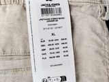 the back of a pair of beige pants with a price tag on it