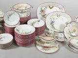 a lot of plates and bowls sitting on a table