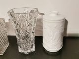 two vases and a sugar shaker sitting on a table