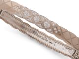 a close up of a bracelet with diamonds on a white background