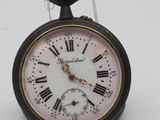 a small clock with roman numerals on it