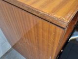 a wooden desk with a drawer and a phone in it