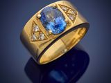 a yellow gold ring with a blue sapphire and diamonds