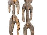 pair of carved wooden figures of a man and a woman