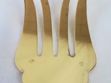 a gold fork with three forks sticking out of it