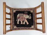 a chair that has an elephant on the back of it