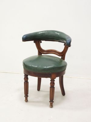 a green chair with a wooden frame and leather seat