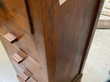 a wooden cabinet with a drawer on top of it