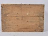 an old wooden box sitting on top of a white surface