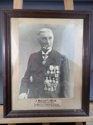 framed photograph of a man in a military uniform in front of a blue wall