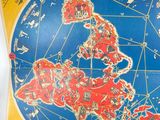 map of the world in red and blue on a yellow background