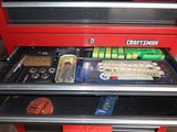 a red tool box with a keyboard and other tools