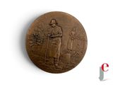 une médaille de bronze sur laquelle figurent un homme et une femme
