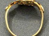 an image of a gold ring with diamonds on a table