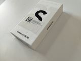 a white box on a table with a black question mark on it
