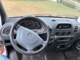 a steering wheel and dashboard of a vehicle with a view of a field