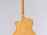 an acoustic guitar hanging from the back of a wall