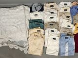 several pairs of men ' s clothing laid out on a table