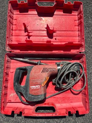 a red box with a drill and a cord in it