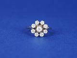 a diamond cluster ring on a blue background