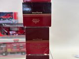 three red boxes stacked on top of each other on a table