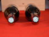 two bottles of wine that are sitting on a table