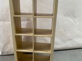 a picture of a wooden bookcase with many shelves