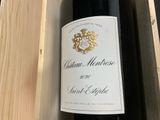a bottle of wine sitting in a wooden box