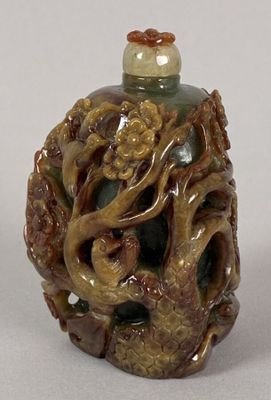 a small bottle with a dragon on it sitting on a table