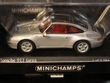 silver porsche 911 tarra with red interior in display case
