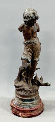 a statue of a boy with a dog on a pedestal