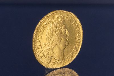 l'image d'une pièce d'or sur laquelle figure une tête de femme