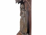 wooden statue of a woman holding a basket of flowers on a pedestal