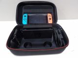 a nintendo switch case with two controllers inside of it