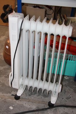 a radiator that is sitting on the floor in a garage