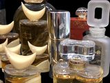 several bottles of perfume are lined up on a black surface